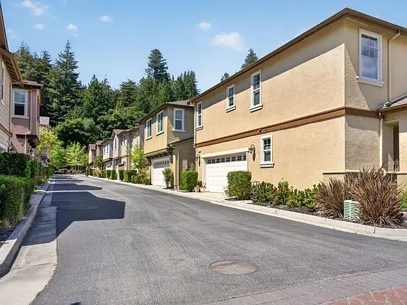Santa Cruz Townhomes for Sale on Quiet Residential Street Exterior view of Santa Cruz townhomes along a quiet residential street with attached garages, landscaped front areas, mature trees, and well-maintained neighborhood surroundings. This image highlights Santa Cruz real estate, townhome property features, curb appeal, and neighborhood presentation during the home selling timeline from listing preparation to buyer showings and closing.